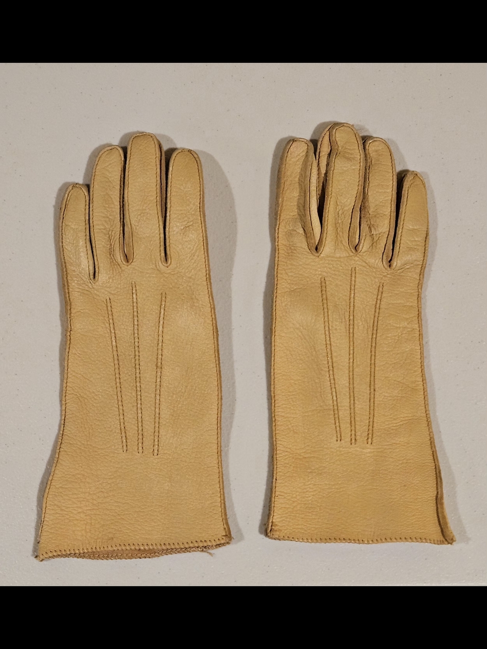 Sophisticated vintage gauntlet-style light tan leather dress gloves.